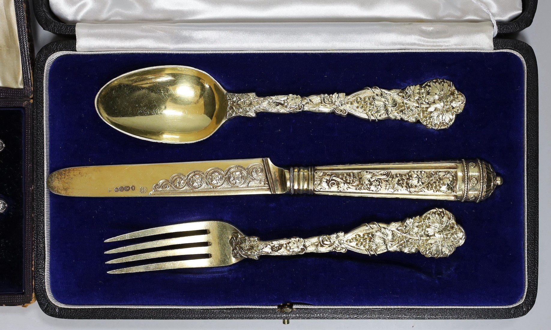 A cased George IV silver gilt christening trio (spoon, knife and fork) by Ely & Fearn, London, 1823 and one other cased Victorian parcel silver gilt trio, Francis Higgins, London, 1848/9.